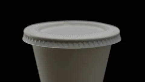 Close-up, macro, disposable cup with ecological cornstarch lid on black Stock Footage 172158087