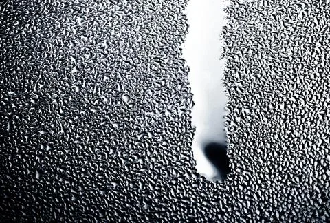 Close up macro drop running down the glass Stock Photos