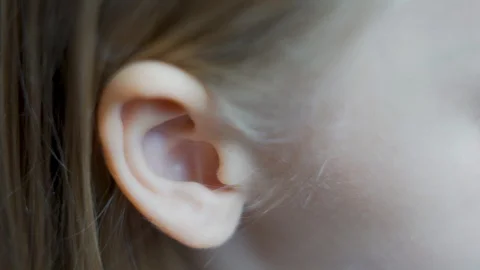 Close-up macro ear of a small child, a small blonde light-skinned small girl kid Stock-Footage 118960123