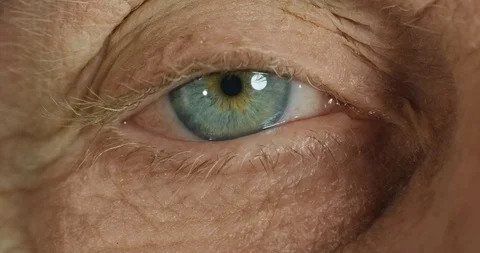 Close up macro eye opening old woman iris contracting natural optical beauty Stock Footage 96958775