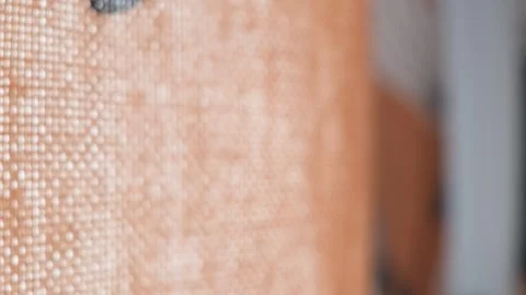 Close up macro of fabric curtains gently swaying in a breeze, soft focus texture Stock Footage 339809548