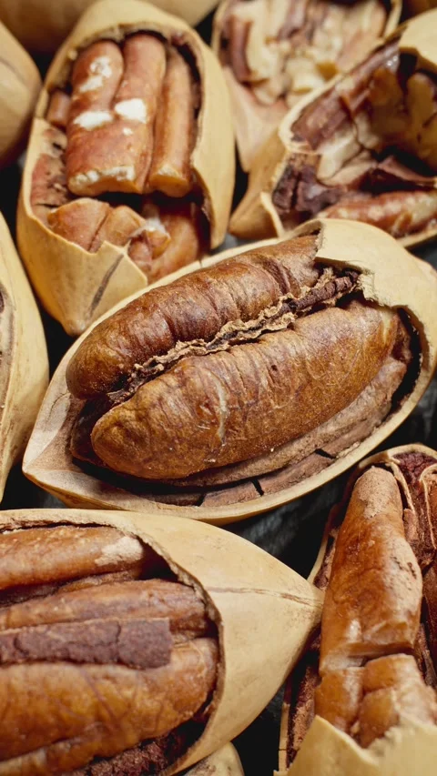 Close-up macro footage of pecans rotates. Pecan background. Tasty nuts. Protein. Stock-Footage 286061248