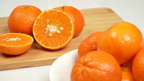 Close Up Macro of Fresh Sliced Orange on Wooden Cutting Board 4K Stock-Footage 319452312