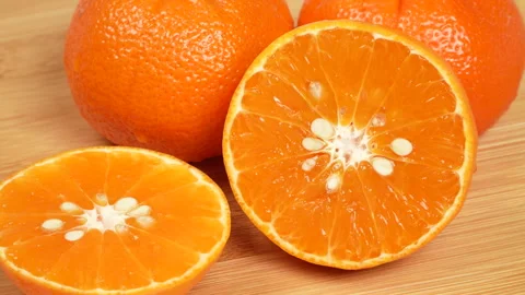 Close Up Macro of Fresh Sliced Orange on Wooden Cutting Board 4K Stock Footage 319452341