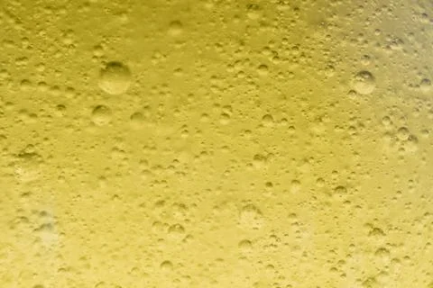 Close-up macro fullscreen with shallow depth of field of bubbles inside a yel Stock Photos