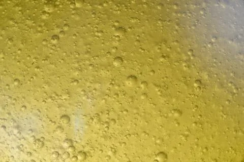 Close-up macro fullscreen with shallow depth of field of bubbles inside a yel Stock Photos