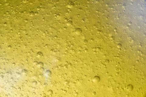 Close-up macro fullscreen with shallow depth of field of bubbles inside a yel Stock Photos