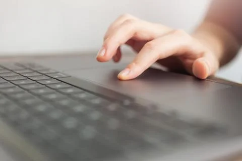 Close up macro of hands typing on black laptop computer keyboard Stock Photos