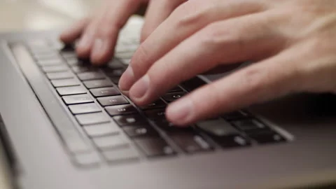 Close up macro of hands typing on laptop keyboard computer Stock Footage 274296799
