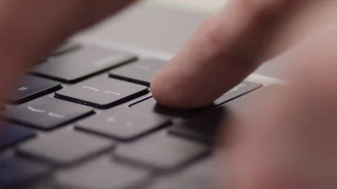 Close up macro of hands typing on laptop keyboard computer Vidéo 274298340