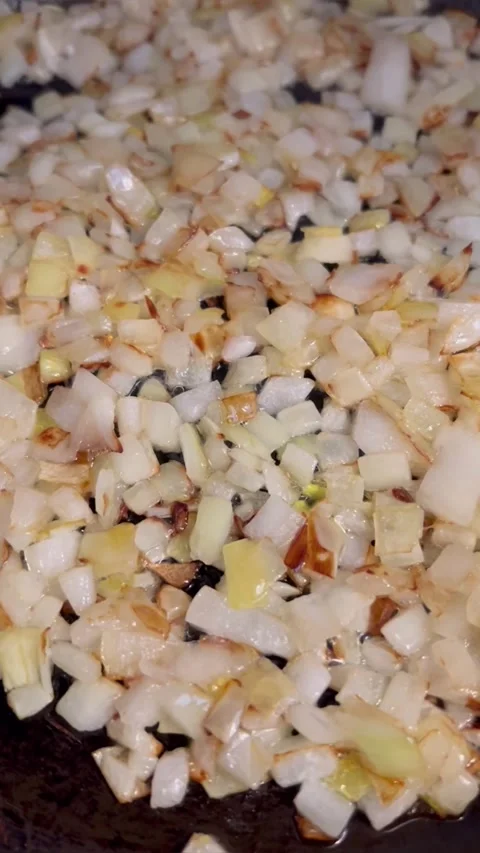 Close up macro horizontal video of frying chopped white onion in oil Stock Footage 310960351