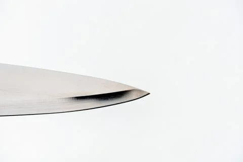 Close up macro image of a silver chrome sharp blade edge with white backgroun Foto stock