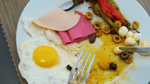 Close-up, macro, person eats an appetizing breakfast. On the plate are steame Stock Footage 120109831