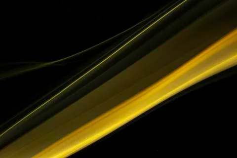 A close up macro photo of a diagonal wisp of orange smoke on a black backgrou Stock Photos