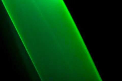 A close up macro photo of a diagonal wisp of green smoke on a black backgroun Stock Photos