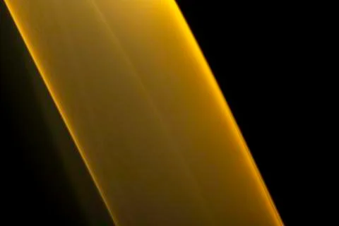 A close up macro photo of a diagonal wisp of orange smoke on a black backgrou Stock Photos