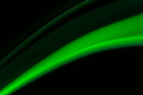 A close up macro photo of a diagonal wisp of green smoke on a black backgroun Stock Photos