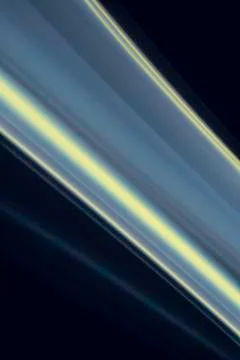 A close up macro photo of a diagonal wisp of smoke lit with blue and yellow f Stock Photos