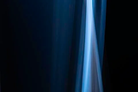A close up macro photo of a vertical wisp of blue smoke on a black background Stock Photos