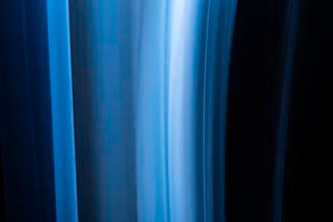 A close up macro photo of a vertical wisp of blue smoke on a black background Stock Photos