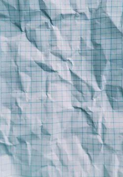Close-up macro photograph of a single sheet of crumpled white graph paper. Stock Photos