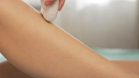 Close-up, Macro Process Of Depilation of Legs. Removal Of Hair on the Leg with a Stock Footage 131527966