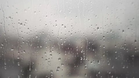 Close up Macro Raindrops flow down the Window Glass and focus shift to the city Stock Footage 339286065