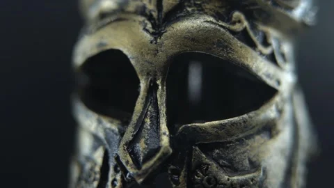 Close macro shot of antique helmet spinning, dark background with dramatic Stock Footage 334162049