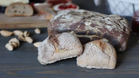 Close-up macro shot of black bread. Rolls lie on a wooden table of dark wood Stock Footage 79831216