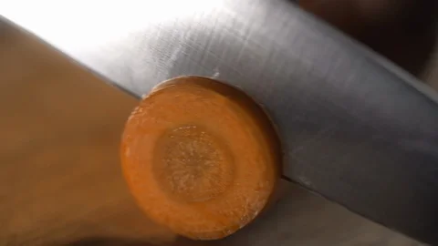 Close up macro shot of chopping raw carrot on the wooden board, cutting Video stock 115124613