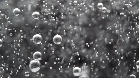 Close up/ Macro shot of clear soda water bubble floating up Stock Footage