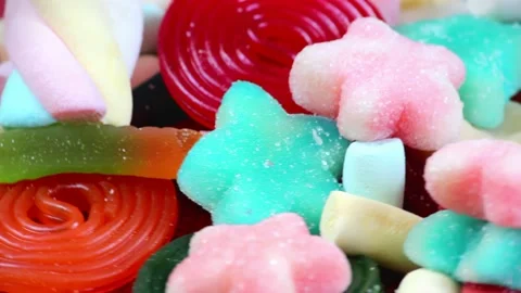 Close-up macro shot of colorful candy sweets moving in a circular motion Stock Footage 236984528