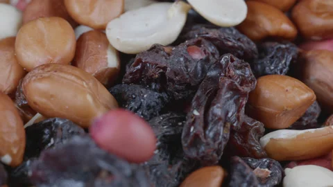 A close up macro shot of dried fruit and nuts slowly rotating. 4K locked tripod Stock Footage 169120343