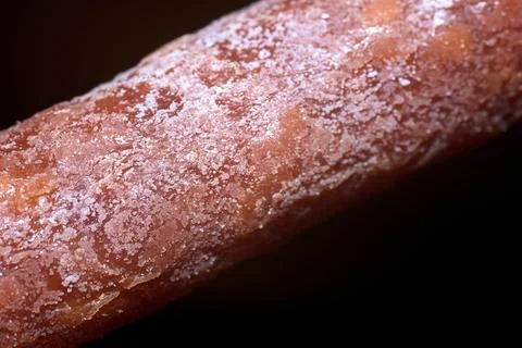 Close-up macro shot of dry cured sausage surface with natural white mold Stock Photos