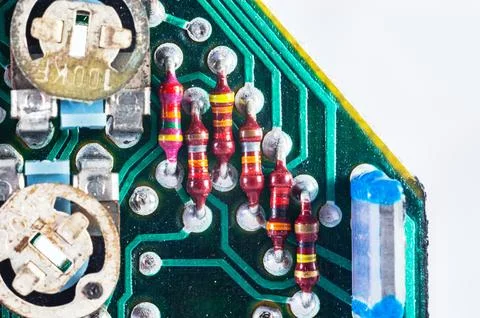 Close-up macro shot of electronic components on a green circuit board with .. Stock Photos