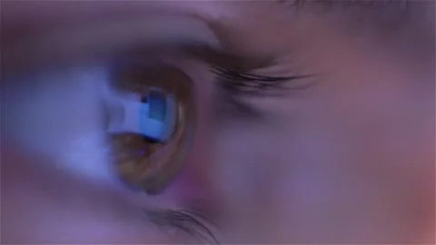 Close up macro shot of eye reflecting computer monitor browsing scrolling Stock Footage 259873988