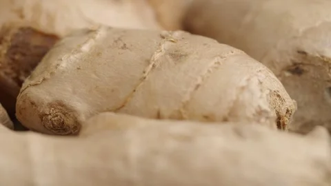 Close up macro shot of fresh ginger root on a decorative surface with golde.. Stock Footage 331985458
