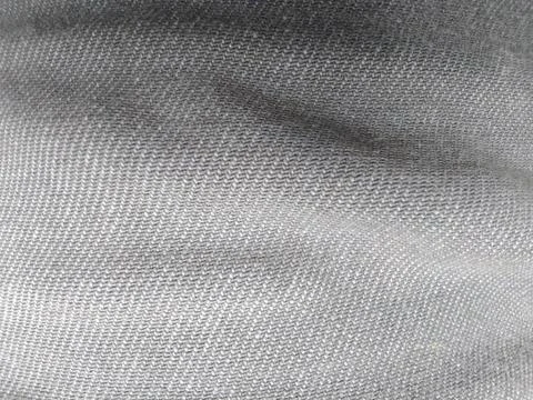 Close-up macro shot of gray denim fabric texture with diagonal lines and su.. Fotos Stock