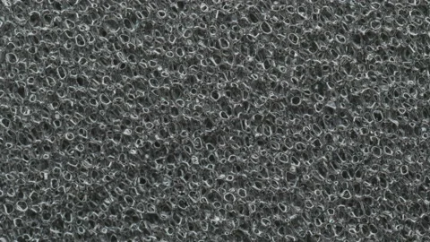 Close up macro shot of grey synthetic packing foam rotating 01. 4K locked tripod Stock Footage 153569415