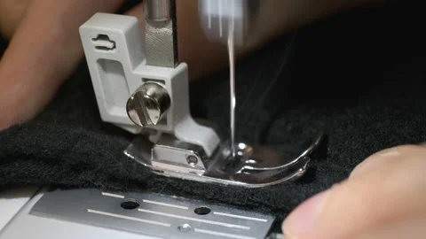 Close up macro shot of hands working on sewing machine Stock Footage 152006956
