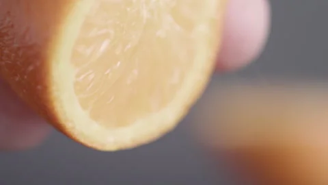 Close up / macro shot of orange being squeezed Stock Footage 273123565