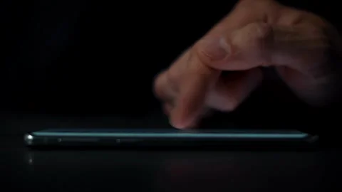 Close-up macro shot of person using smartphone browsing pictures on social Video stock 336249228