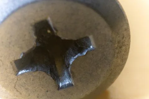 A close-up macro shot of a Phillips head screw, showing its cross-shaped slot Stock Photos