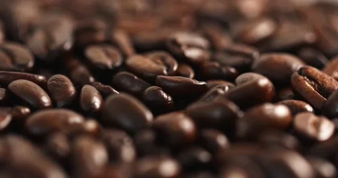 Close up macro shot of roasted brown Arabica coffee beans rotating 360 degrees Stock Footage