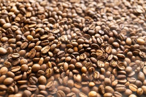 Close-up macro shot of roasted coffee beans, showcasing their rich texture .. Stock Photos