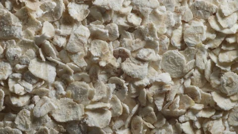 Close up macro shot of rolled oats slowly rotating. 4K locked tripod shot. Stock Footage 153767779