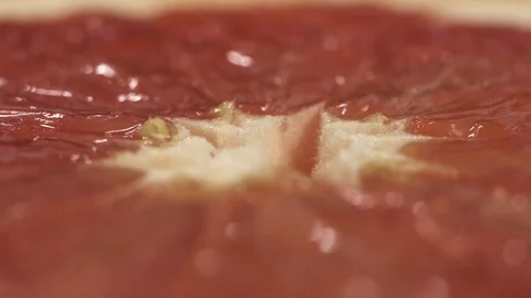 Close up macro shot of rotating grapefruit on the table. Extreme close up Stock Footage 126253133
