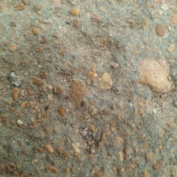 Close up macro shot of rough sandy ground texture with small pebbles 写真素材