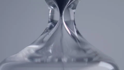 Close up macro shot of sand clock / hourglass sand pouring in slow motion. Video stock 273113922