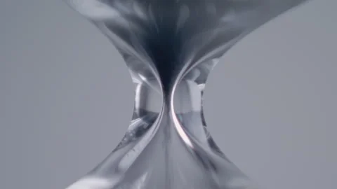 Close up macro shot of sand clock / hourglass sand pouring in slow motion. Video stock 273113931